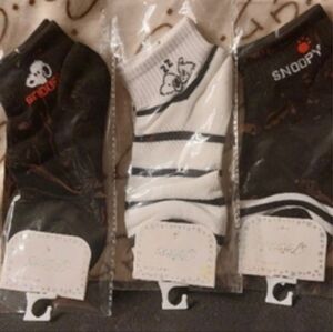 What is Snoopy up to? 2 black pairs & 1 white & stripe pair ankle socks.size 7-9